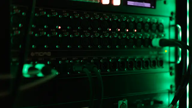 Patch panel with status indicators lit across the front.